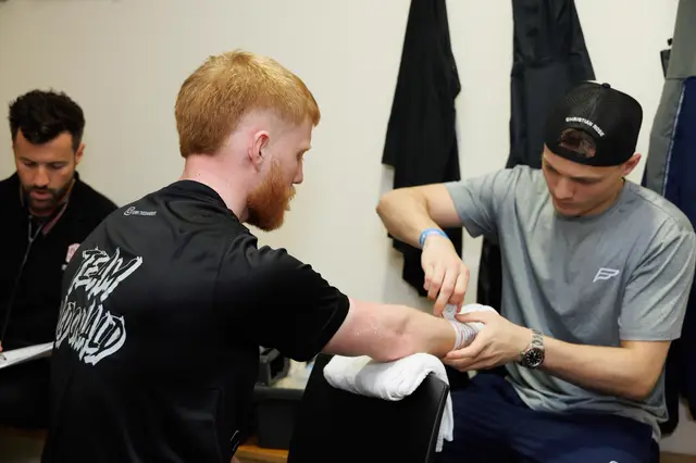 Matthew having his hands wrapped in the changing room