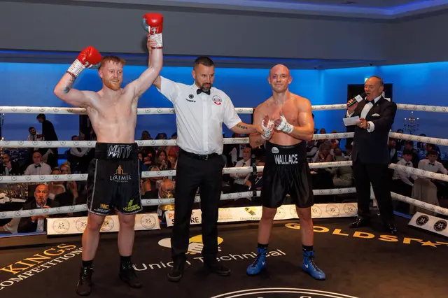 The referee raising Matthew's hand after his pro debut against Steven Wallace